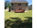 Expansive backyard featuring a deck, lush green grass, and plenty of space for outdoor activities at 9405 Bandywood Dr, Covington, GA 30014