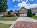 Charming brick home with a spacious driveway and attached two-car garage, surrounded by lush landscaping at 2826 Staunton Dr, Duluth, GA 30097