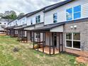 Row of townhomes featuring cozy, covered back porches ideal for outdoor relaxation at 5722 Urban Village Way # 8, Tucker, GA 30084