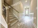 Elegant staircase design with wood treads, iron railings, and wainscoting at 5722 Urban Village Way # 8, Tucker, GA 30084