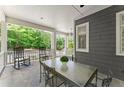 Relaxing back porch with seating, a table, and a view of the surrounding trees at 922 Pebblebrook Se Rd, Mableton, GA 30126