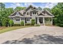 Beautiful two-story home boasting lush landscaping, a circular driveway and craftsman-style details at 922 Pebblebrook Se Rd, Mableton, GA 30126