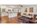Open-concept living area featuring a kitchen with stainless steel appliances and wood flooring at 3344 Ridgecrest Dr, Powder Springs, GA 30127