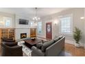 Inviting living room with a brick fireplace, hardwood floors, and a charming front entrance at 537 Winton Ne Ter, Atlanta, GA 30308