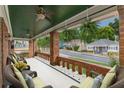 Inviting covered porch with brick columns, ceiling fans, and comfortable seating overlooking the neighborhood at 537 Winton Ne Ter, Atlanta, GA 30308
