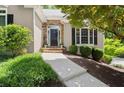 Inviting front entry with stone accents, a walkway, and lush landscaping at 4445 Ansley Ln, Cumming, GA 30040