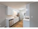 Bright kitchen featuring stainless steel appliances, white cabinets, and modern countertops at 5964 W Fayetteville Rd, Atlanta, GA 30349