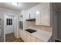 Bright kitchen with stainless steel oven and cooktop, white cabinets, and modern countertops at 5964 W Fayetteville Rd, Atlanta, GA 30349