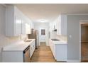 Well-lit kitchen featuring modern appliances, white cabinets, and new countertops at 5964 W Fayetteville Rd, Atlanta, GA 30349