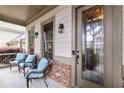 Inviting front porch with seating area, decorative glass door, and brick accents for added curb appeal at 663 Warm Springs Ct, Loganville, GA 30052