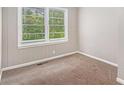 Cozy bedroom with neutral carpet, fresh paint and a large window at 3456 Maryvale Dr, Decatur, GA 30032
