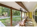 Covered porch with seating, perfect for enjoying the outdoor scenery, with a view of the surrounding greenery at 5357 Highway 81, Loganville, GA 30052