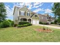 Well-manicured lawn and landscaping complement this lovely home with a two-car garage at 216 Toonigh Way, Canton, GA 30115