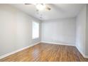 Comfortable bedroom with wood floors, neutral paint and ceiling fan, offering a serene living space at 2928 George Busbee Pkwy, Kennesaw, GA 30144