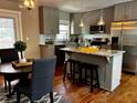 Well-lit kitchen with stainless steel appliances and breakfast bar with granite counters at 3153 Bonway Dr, Decatur, GA 30032