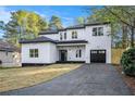 Beautifully designed home with a paved driveway leading to a garage at 3444 Underwood Se Ct, Conyers, GA 30013