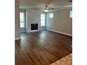 Spacious living room with a modern fireplace, large windows, and durable hardwood flooring at 4180 Cavalier Way, Duluth, GA 30097