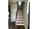 Traditional staircase featuring hardwood treads and white risers leads to the upper level at 4180 Cavalier Way, Duluth, GA 30097