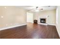 Spacious living room featuring hardwood floors, a fireplace, and neutral wall color at 5427 Highway 81, Loganville, GA 30052