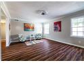 Cozy living area with wood-look floors, natural light from windows, and accent chairs for modern appeal at 3626 Buford Ne Hwy # C2, Brookhaven, GA 30329