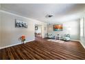 Bright living room showcasing wood-look floors, neutral walls, and tasteful decor with a glimpse into dining area at 3626 Buford Ne Hwy # C2, Brookhaven, GA 30329