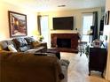 Comfortable living room with a decorative fireplace, sofa and large TV at 9400 Roberts Dr # 7M, Atlanta, GA 30350