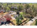 Aerial view of the home showing the home's location near a pond, surrounded by mature trees at 13090 Magnolia Crescent Dr, Roswell, GA 30075