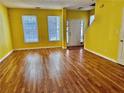 Spacious living room with hardwood floors, large windows, and ample natural light at 4842 Hairston Park Sq, Stone Mountain, GA 30083