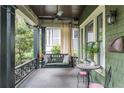Relaxing front porch with swing, ceiling fan, and vintage-style outdoor lighting at 541 Greenwood Ne Ave, Atlanta, GA 30308