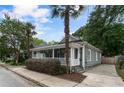 Charming home featuring a covered front porch, with lush landscaping and a private driveway at 206 Flora Ne Ave, Atlanta, GA 30307