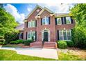 Elegant brick home featuring multiple windows with black shutters and a well-maintained yard at 213 Shady Valley Dr, Carrollton, GA 30116