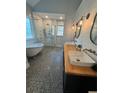 Bright bathroom featuring a soaking tub, glass shower, and double vanity with wood countertop at 4080 Longford Ne Dr, Marietta, GA 30066