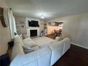 Open living room with a fireplace and a large sectional sofa at 4080 Longford Ne Dr, Marietta, GA 30066