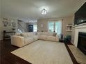 Inviting living room with large sectional sofa, fireplace, and hardwood floors at 4080 Longford Ne Dr, Marietta, GA 30066