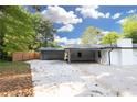 Back view of a home with a carport and concrete driveway surrounded by a fenced yard at 4166 Idlevale Dr, Tucker, GA 30084