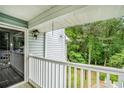 View from balcony shows exterior of condo building and nature with trees and green grass at 2748 Suwanee Se Way, Marietta, GA 30067