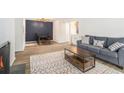 Stylish living room with modern decor, an electric fireplace, and an adjacent dining area at 2748 Suwanee Se Way, Marietta, GA 30067