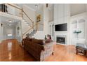 Bright living room with high ceilings, fireplace, built-in shelving, and hardwood floors at 3524 Old Towne Ln, Cumming, GA 30040