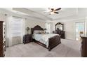 Spacious main bedroom with tray ceiling, plush carpet, and elegant furnishings at 3524 Old Towne Ln, Cumming, GA 30040
