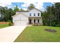Charming two-story home with a well-manicured lawn and a welcoming front porch and attached two car garage at 63 Brookstone E Park, Acworth, GA 30101