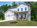 Charming two-story home featuring stone accents, a covered porch, and an attached two-car garage at 63 Brookstone E Park, Acworth, GA 30101