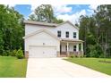 Charming two-story home with a well-manicured lawn and a welcoming front porch and attached two car garage at 63 Brookstone E Park, Acworth, GA 30101