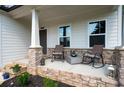 Relaxing front porch with stone accents, rocking chairs, and stylish decor for a cozy outdoor space at 63 Brookstone E Park, Acworth, GA 30101