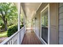 Inviting front porch featuring a white railing and views of the lush greenery at 1491 Kolb Ridge Sw Dr, Marietta, GA 30008