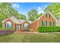 Beautiful brick home with well-maintained landscaping and green shutters at 2333 Orion Ct, Grayson, GA 30017