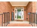 Welcoming front porch with brick accents, black railings, and decorative touches at 2333 Orion Ct, Grayson, GA 30017