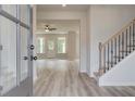 Bright entryway featuring wood-look flooring, a staircase, and an open view to the living area at 234 Linford Dr, Locust Grove, GA 30248