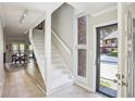 Inviting foyer with white staircase and large window offering natural light at 3268 Clairmont Ne, Brookhaven, GA 30329