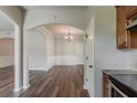 Elegant dining room with wood floors, wainscoting, chandelier, and open arched doorway to adjacent living space at 5567 Union Pointe Pl, Union City, GA 30291