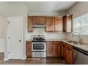 Modern kitchen featuring stainless steel appliances, beautiful granite countertops, and ample wooden cabinetry at 5567 Union Pointe Pl, Union City, GA 30291